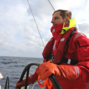 Martin at the helm of Visit Seattle, a 70-foot racing yacht, during his North Pacific sail
